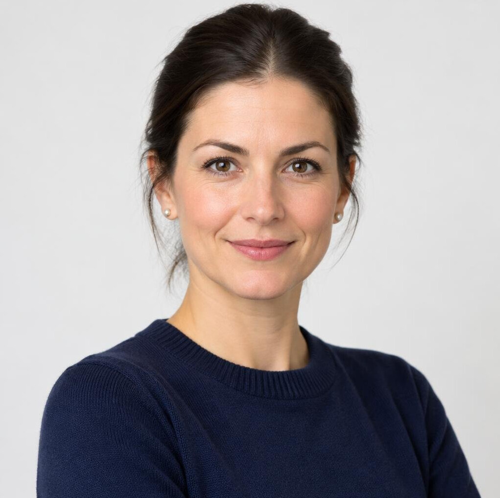 Portrait of a confident woman with dark hair in a navy sweater