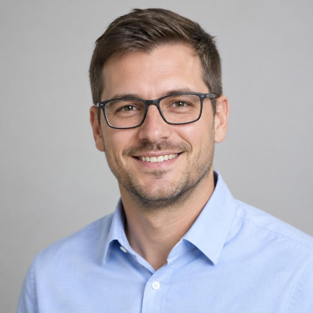 Smiling man with glasses in a light blue shirt portrait